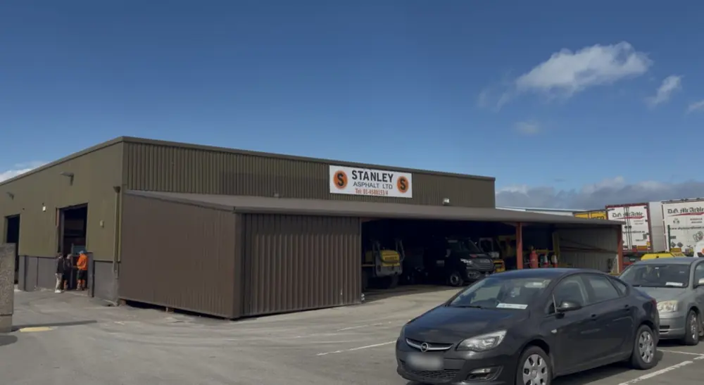 The Stanley Asphalt depot, its sign over the open bays where the machines are kept.